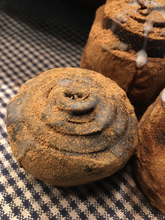 Load image into Gallery viewer, Blackened bees wax hand rolled Cinnamon Roll.